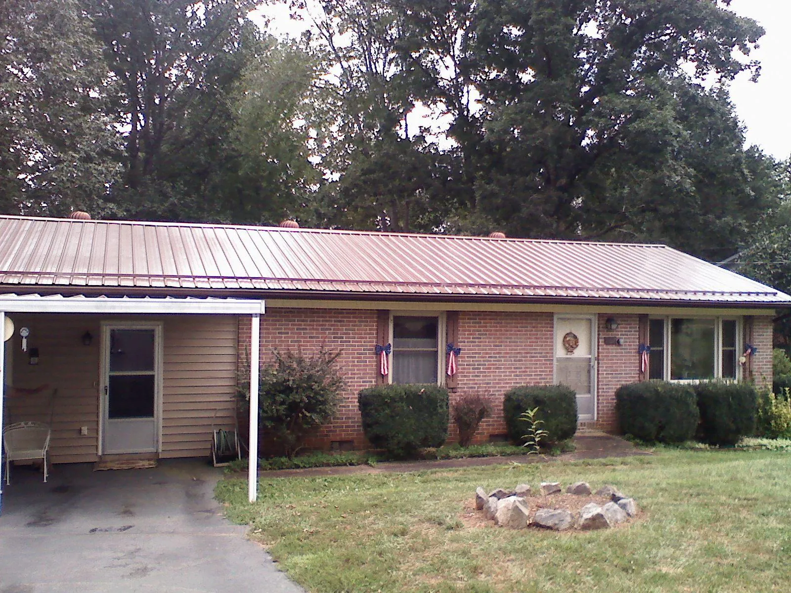 Bronze metal roof and carport on a brick ranch home — Roof Repair work by our crew in Elbe