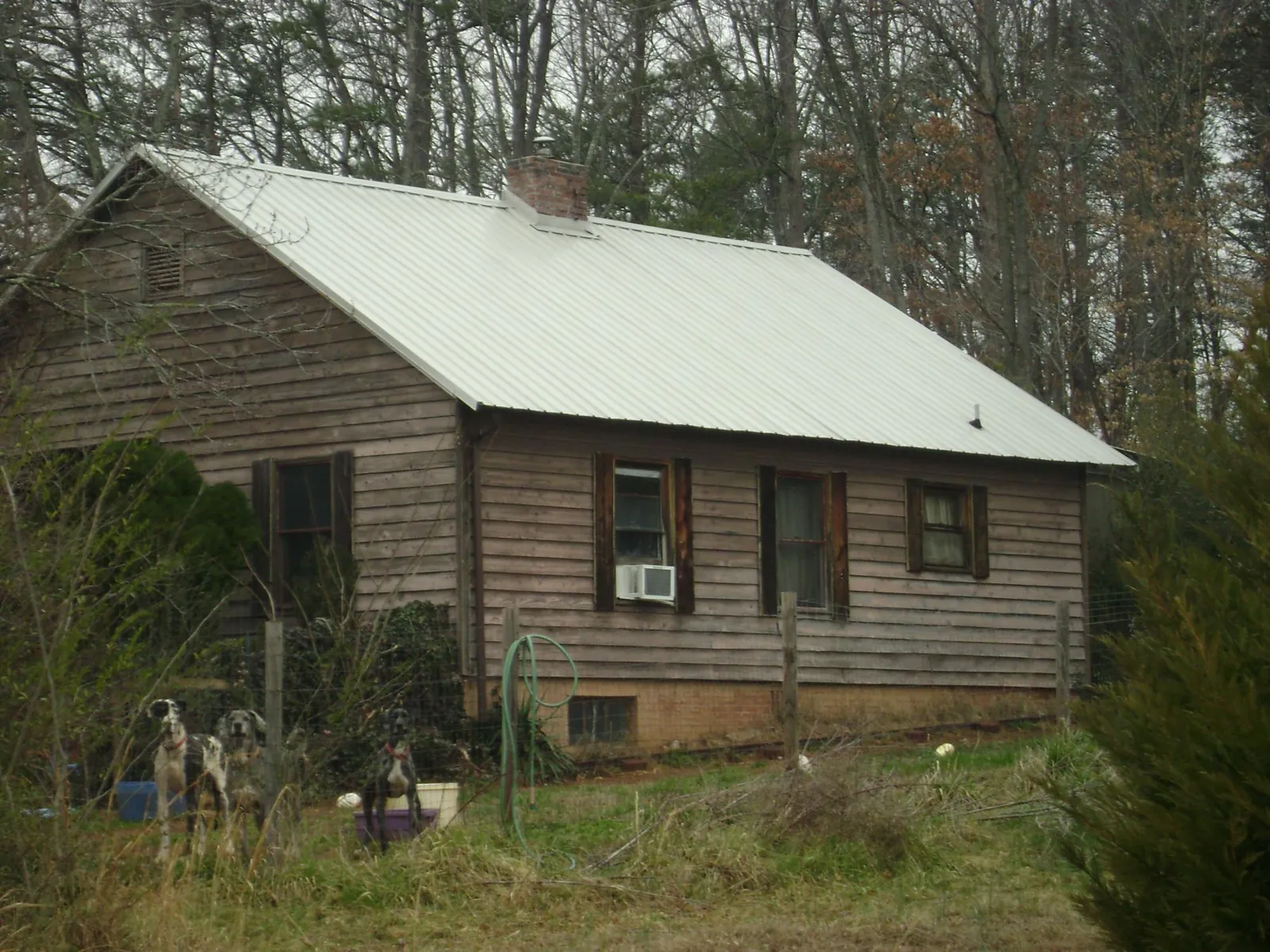 White metal roof on an old wood sided farmhouse, from a Metal Roof Installation job in Elbe